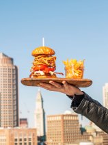 YOTEL Boston burger and fries with the Boston skyline
