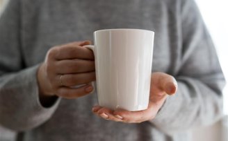 Person holding a mug